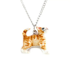 A hand-painted porcelain pendant in the shape of a ginger kitten, attached to a silver plated chain