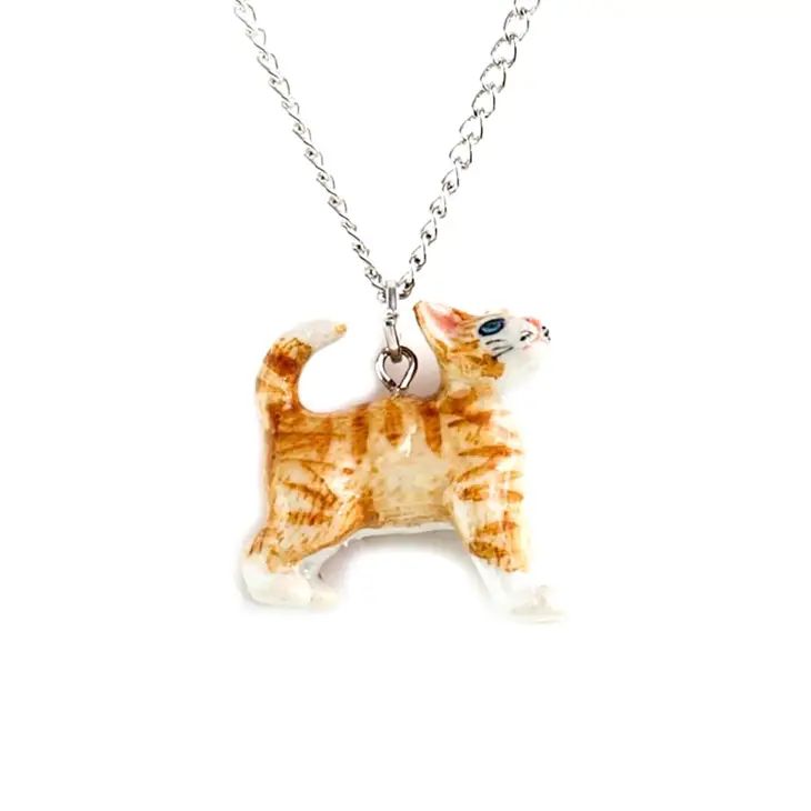 A hand-painted porcelain pendant in the shape of a ginger kitten, attached to a silver plated chain