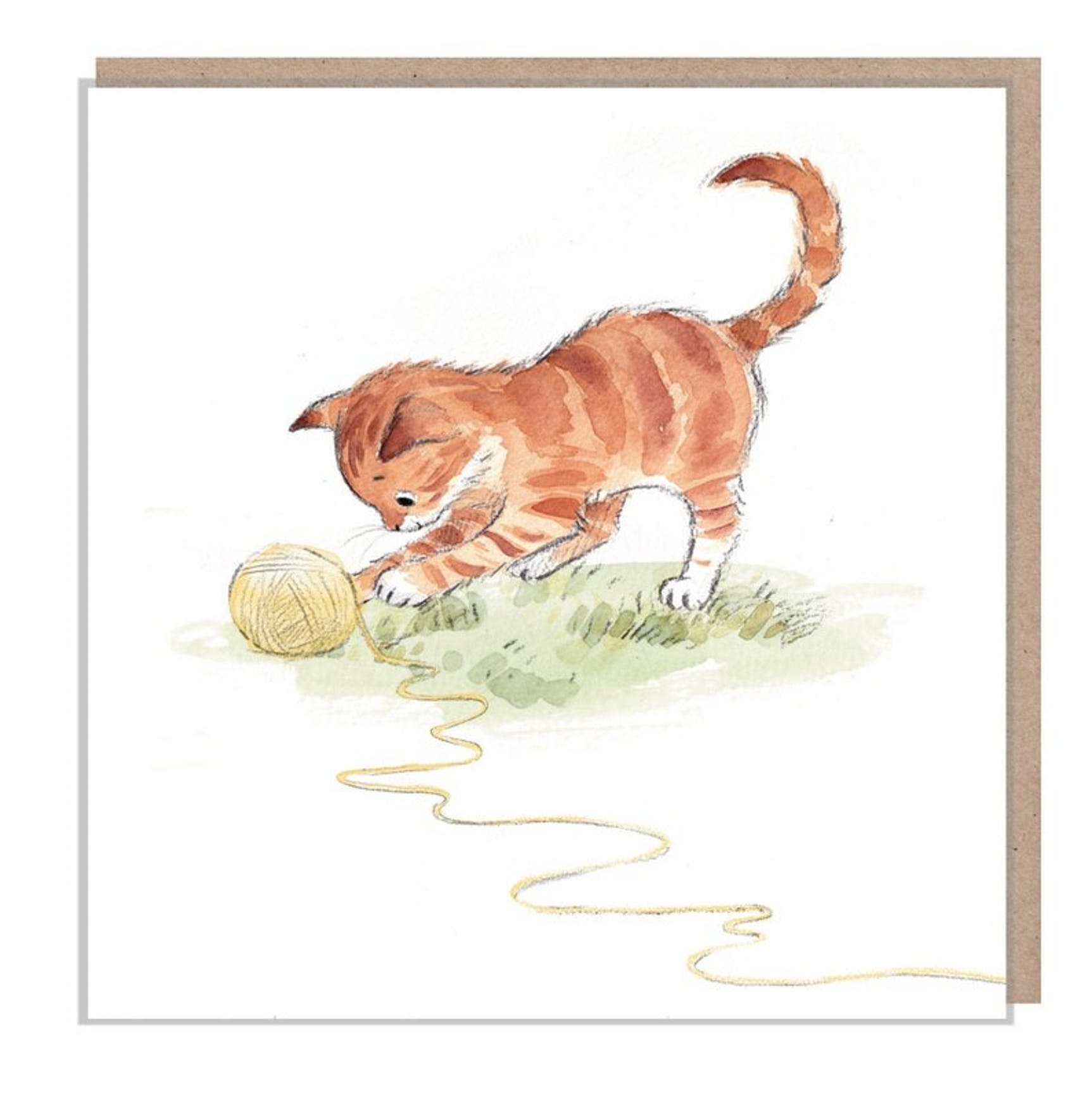 Ginger Cat Playing with Wool Card